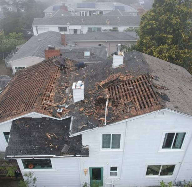Damaged roof exposing wood frame