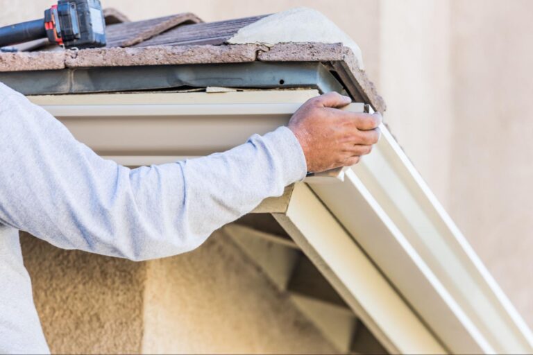 roofing contractor inspecting storm damage and failing flashing on a residential roof