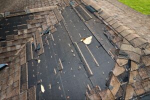 sun damaged asphalt shingles showing curling, cracking, and granule loss before roof repair